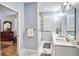 Chic bathroom features marble floors, dual vanity, and a glass enclosed shower at 340 N River Rd, Venice, FL 34293