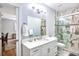 Bathroom featuring marble flooring, a sleek vanity, and a glass-enclosed shower with elegant design at 340 N River Rd, Venice, FL 34293