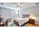 Cozy bedroom featuring a ceiling fan, natural light, and soft decor with hardwood flooring at 340 N River Rd, Venice, FL 34293