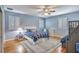 Bedroom with blue accents, plantation shutters, and beautiful hardwood floors at 340 N River Rd, Venice, FL 34293