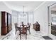 Formal dining room with bay window, marble floors and elegant chandelier at 340 N River Rd, Venice, FL 34293