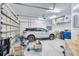 Spacious garage with epoxy flooring, modern car, and ample storage space at 340 N River Rd, Venice, FL 34293
