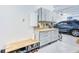 Organized garage features cabinets, work bench, and a clean epoxy floor at 340 N River Rd, Venice, FL 34293