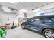 Spacious garage with epoxy floors features plenty of storage space and a parked SUV at 340 N River Rd, Venice, FL 34293