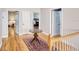 Hallway featuring hardwood floors, neutral walls, and decorative rug between rooms at 340 N River Rd, Venice, FL 34293
