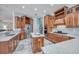 Gourmet kitchen with marble countertops, stainless steel appliances and custom wood cabinetry at 340 N River Rd, Venice, FL 34293