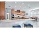 Kitchen features marble countertops, stainless steel appliances, breakfast bar with stools and a dining table at 340 N River Rd, Venice, FL 34293