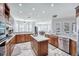 Bright kitchen with marble floors, island, stainless steel appliances and a breakfast table with chairs at 340 N River Rd, Venice, FL 34293