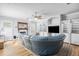 Living room boasts a large blue couch, fireplace, built-in shelves, and wood floors at 340 N River Rd, Venice, FL 34293