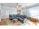 Living room features a large blue sectional couch, decorative rug, and bright natural lighting at 340 N River Rd, Venice, FL 34293