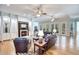 Elegant living room with fireplace, hardwood floors, and plenty of natural light at 340 N River Rd, Venice, FL 34293