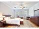 Main bedroom showcases wood floors, a ceiling fan, plantation shutters and a large dresser at 340 N River Rd, Venice, FL 34293