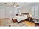 Main bedroom boasts wood floors, a ceiling fan, plantation shutters and a sitting area at 340 N River Rd, Venice, FL 34293