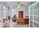 Spacious office featuring hardwood floors, a large wooden desk and a bookcase at 340 N River Rd, Venice, FL 34293