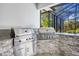 The outdoor kitchen features stainless steel grills, granite countertops, and a brick backsplash at 340 N River Rd, Venice, FL 34293