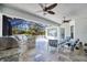 Outdoor living area boasts a summer kitchen with a built-in grill, fans, and comfortable seating at 340 N River Rd, Venice, FL 34293