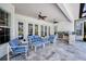 Relaxing outdoor living space offers ample seating, a summer kitchen, and a serene ambiance at 340 N River Rd, Venice, FL 34293