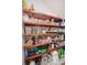 Well-stocked pantry with wooden shelves filled with a variety of food and household items at 340 N River Rd, Venice, FL 34293