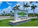 A sign for CoolToday Park surrounded by lush green grass and palm trees at 340 N River Rd, Venice, FL 34293