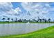 Scenic view of a pond with a fountain in front of the CoolToday Park baseball stadium and palm trees at 340 N River Rd, Venice, FL 34293
