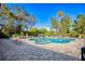 Community pool with hot tub, relaxing chairs and lush green surroundings at 340 N River Rd, Venice, FL 34293