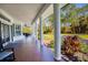 Covered front porch with brick flooring, columns, and comfortable seating for outdoor enjoyment at 340 N River Rd, Venice, FL 34293