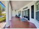 Spacious front porch with brick flooring and classic columns provides shade and an inviting entrance at 340 N River Rd, Venice, FL 34293