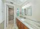 Bathroom with walk-in shower, granite countertop, and modern vanity at 340 Three Lakes Ln # K, Venice, FL 34285