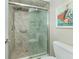 Shower with glass enclosure and neutral tile at 340 Three Lakes Ln # K, Venice, FL 34285