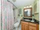 Guest bathroom with patterned shower curtain and granite countertop at 340 Three Lakes Ln # K, Venice, FL 34285