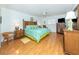 Main bedroom with wood floors, king-size bed, and ceiling fan at 340 Three Lakes Ln # K, Venice, FL 34285