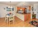 Bright dining area adjacent to kitchen with wood flooring at 340 Three Lakes Ln # K, Venice, FL 34285