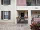 Condo entryway with lush potted plants and brick accents at 340 Three Lakes Ln # K, Venice, FL 34285