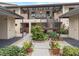 Exterior view of condo building with well-maintained landscaping and walkway at 340 Three Lakes Ln # K, Venice, FL 34285