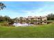 Condo community with lake view and lush landscaping at 340 Three Lakes Ln # K, Venice, FL 34285