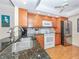 Modern kitchen with granite countertops and stainless steel appliances at 340 Three Lakes Ln # K, Venice, FL 34285
