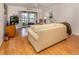 Bright living room with wood floors, sliding glass doors, and lake view at 340 Three Lakes Ln # K, Venice, FL 34285