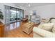 Spacious living room with view of lake from sliding doors at 340 Three Lakes Ln # K, Venice, FL 34285