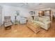 Relaxing living room with wood floors and sliding glass doors at 340 Three Lakes Ln # K, Venice, FL 34285