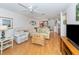 Comfortable living room with wood flooring and view to patio at 340 Three Lakes Ln # K, Venice, FL 34285