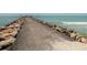 Pathway pier over rocks leading to the ocean at 340 Three Lakes Ln # K, Venice, FL 34285