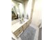 Well-lit bathroom with a large mirror, vanity with storage, and neutral tones at 346 Mariner Dr, North Port, FL 34287