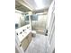 Bathroom showing a toilet, vanity, bath and shower combo with glass doors at 346 Mariner Dr, North Port, FL 34287