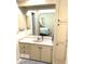 Bathroom vanity with a large mirror reflecting the bedroom and ample storage at 346 Mariner Dr, North Port, FL 34287