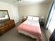 Bedroom featuring a wood dresser, bedside tables with lamps, and a window at 346 Mariner Dr, North Port, FL 34287