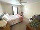 Bedroom with neutral walls, ceiling fan, and furnishings including a dresser at 346 Mariner Dr, North Port, FL 34287