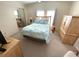 Serene bedroom with wood furniture and a bright window, creating a relaxing retreat at 346 Mariner Dr, North Port, FL 34287