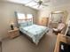 Bright bedroom with natural light, a ceiling fan, and an adjoining bathroom at 346 Mariner Dr, North Port, FL 34287