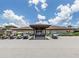 Community building with a covered entrance and golf cart parking spots at 346 Mariner Dr, North Port, FL 34287
