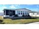 Quaint single-story home with screened porch and lush green lawn in a quiet neighborhood at 346 Mariner Dr, North Port, FL 34287